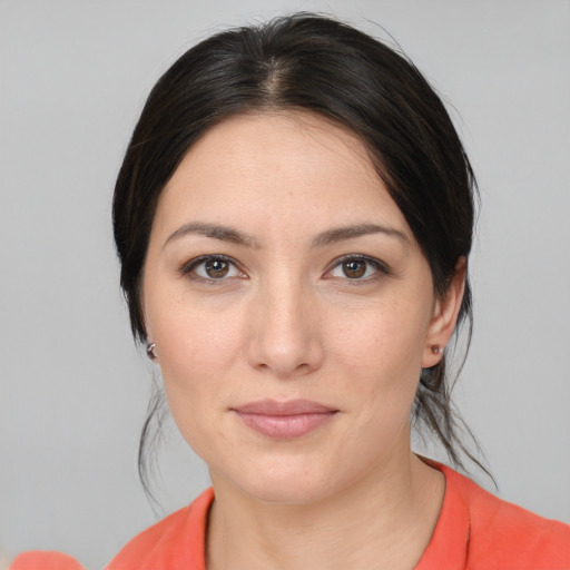 Joyful white young-adult female with medium  black hair and brown eyes