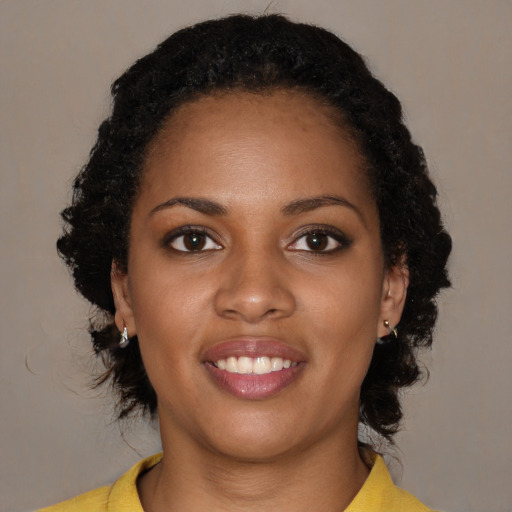 Joyful black young-adult female with medium  brown hair and brown eyes