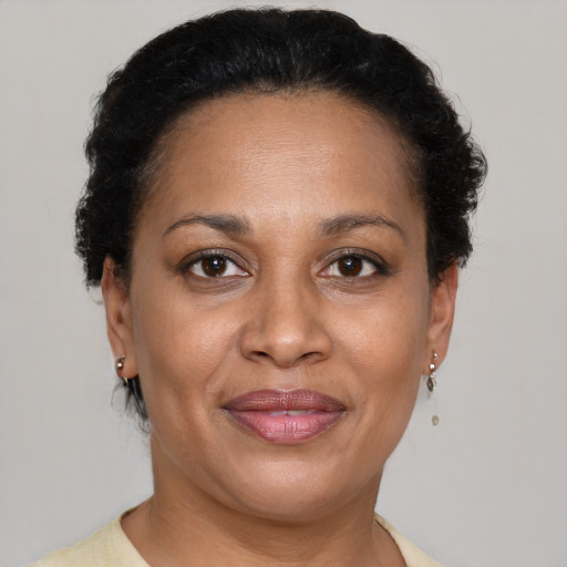 Joyful black adult female with short  brown hair and brown eyes