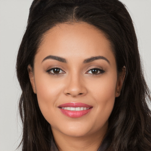 Joyful white young-adult female with long  brown hair and brown eyes