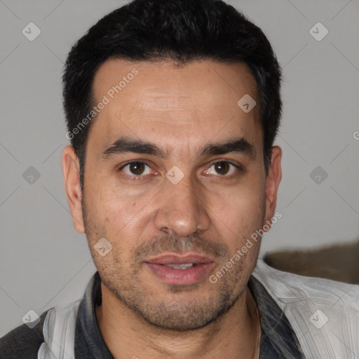Joyful white adult male with short  black hair and brown eyes