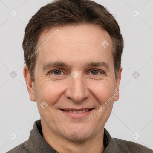 Joyful white adult male with short  brown hair and grey eyes