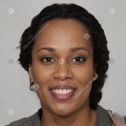 Joyful black adult female with medium  brown hair and brown eyes