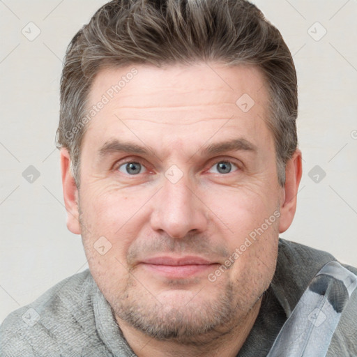 Joyful white adult male with short  brown hair and grey eyes