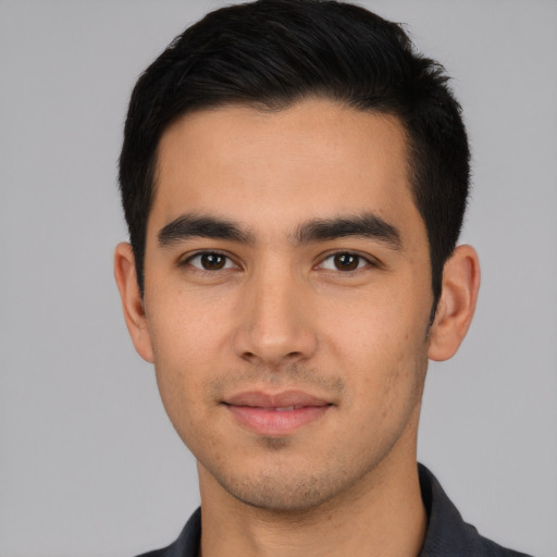 Joyful latino young-adult male with short  black hair and brown eyes