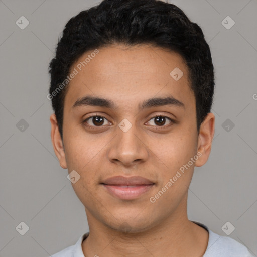 Joyful latino young-adult male with short  black hair and brown eyes