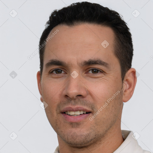 Joyful white young-adult male with short  black hair and brown eyes