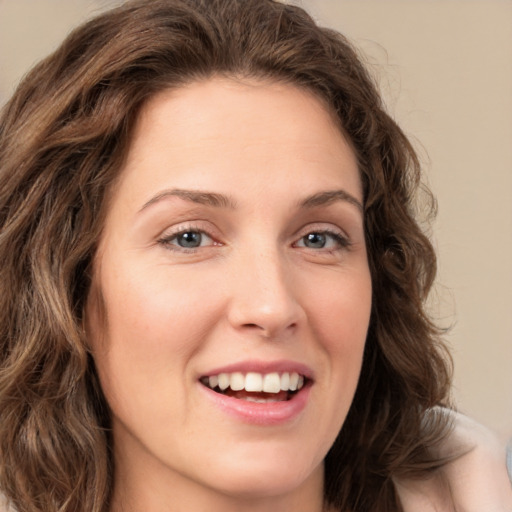 Joyful white young-adult female with long  brown hair and green eyes