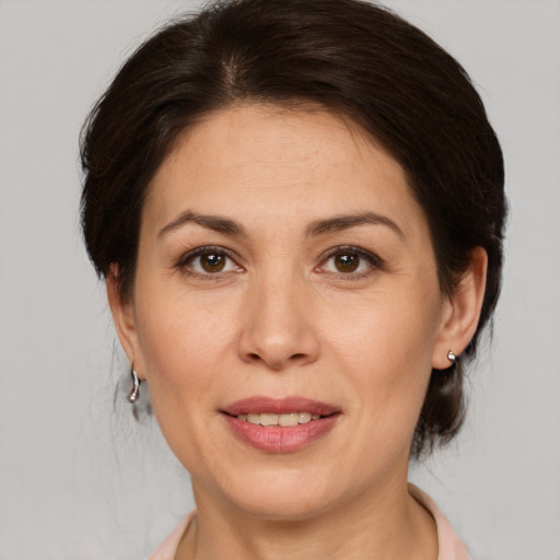 Joyful white adult female with medium  brown hair and brown eyes