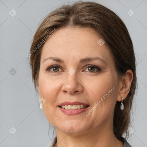 Joyful white adult female with medium  brown hair and brown eyes