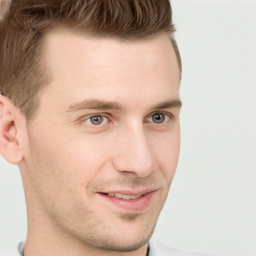 Joyful white young-adult male with short  brown hair and grey eyes