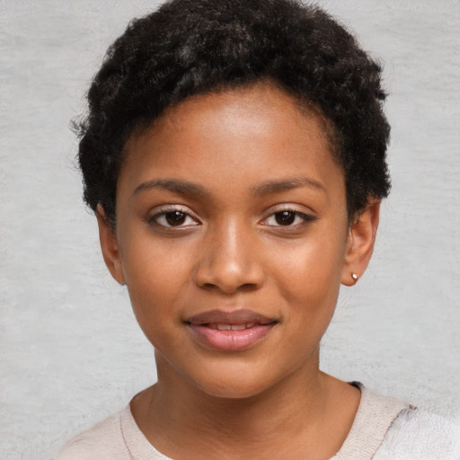 Joyful black child female with short  black hair and brown eyes