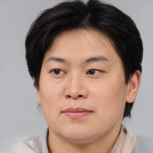 Joyful asian adult female with medium  brown hair and brown eyes