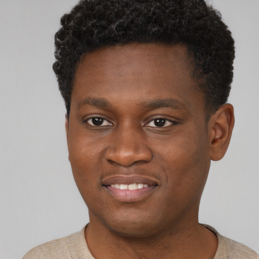 Joyful black young-adult male with short  brown hair and brown eyes