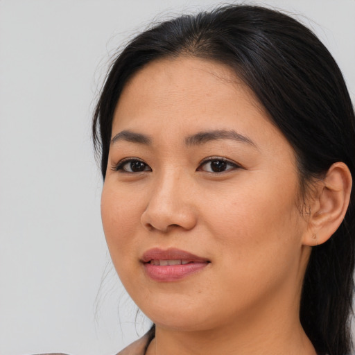 Joyful asian young-adult female with medium  brown hair and brown eyes