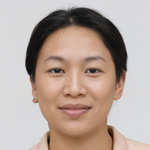 Joyful asian young-adult female with short  brown hair and brown eyes