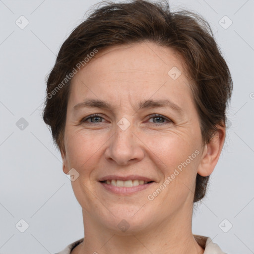 Joyful white adult female with short  brown hair and brown eyes