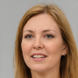 Joyful white adult female with long  brown hair and brown eyes