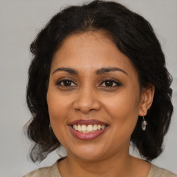 Joyful black young-adult female with medium  brown hair and brown eyes