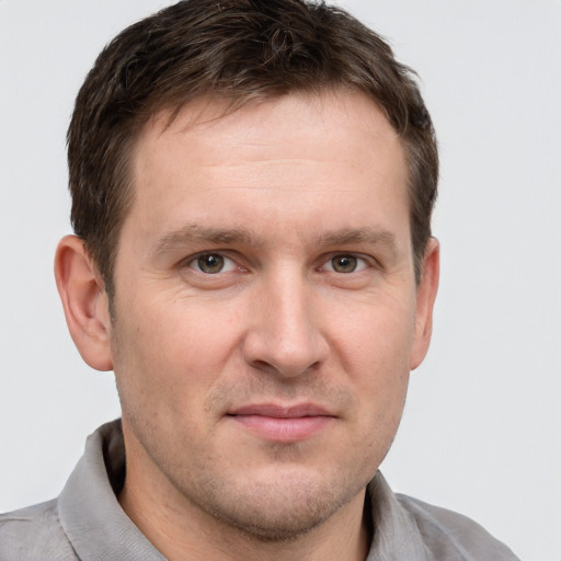 Joyful white adult male with short  brown hair and grey eyes