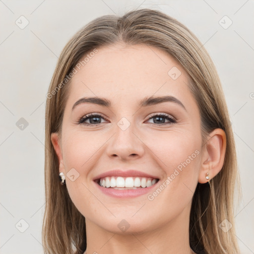 Joyful white young-adult female with long  brown hair and grey eyes