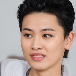 Joyful asian young-adult female with short  black hair and brown eyes