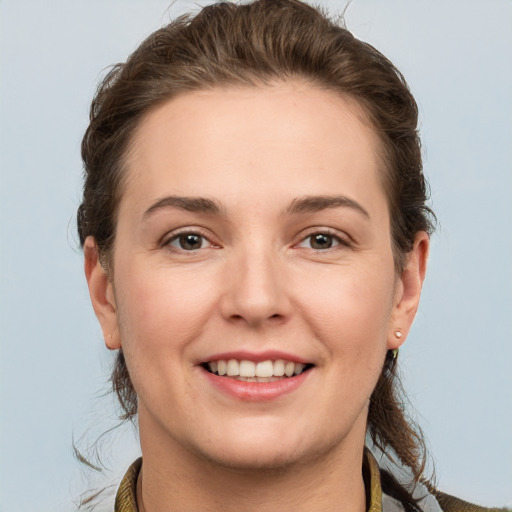 Joyful white young-adult female with short  brown hair and grey eyes