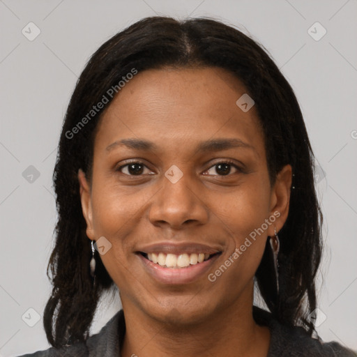 Joyful black young-adult female with long  brown hair and brown eyes