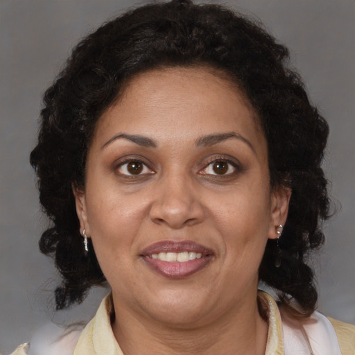 Joyful latino adult female with medium  brown hair and brown eyes