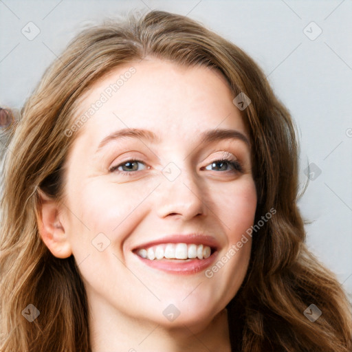 Joyful white young-adult female with long  brown hair and blue eyes