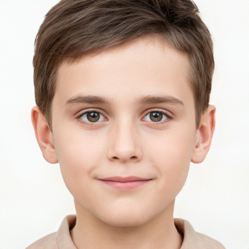 Joyful white child male with short  brown hair and grey eyes