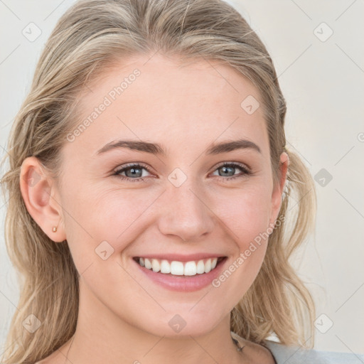 Joyful white young-adult female with long  brown hair and blue eyes