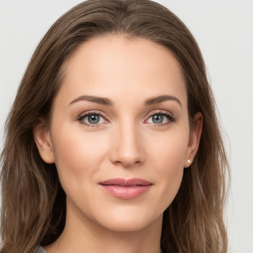 Joyful white young-adult female with long  brown hair and grey eyes