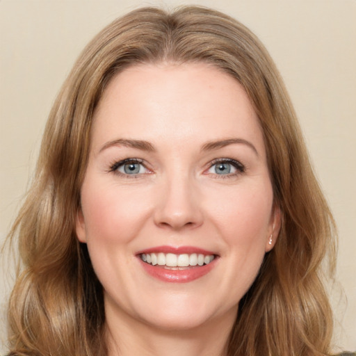 Joyful white young-adult female with long  brown hair and green eyes