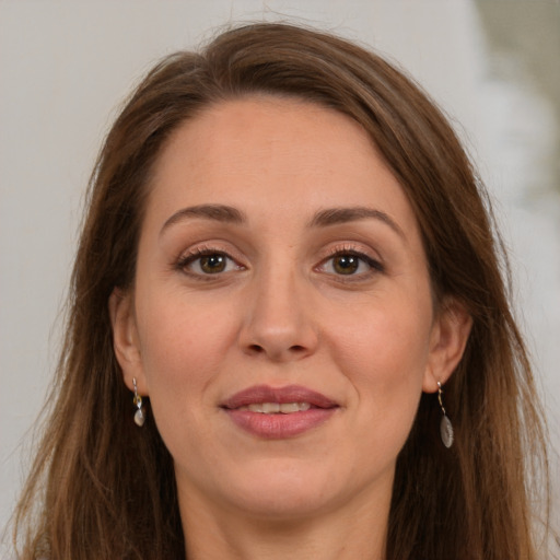 Joyful white adult female with long  brown hair and brown eyes