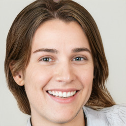 Joyful white young-adult female with medium  brown hair and green eyes