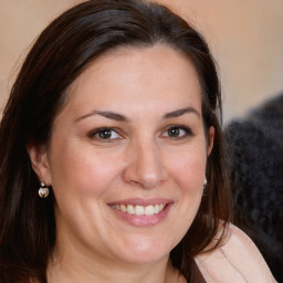 Joyful white adult female with medium  brown hair and brown eyes