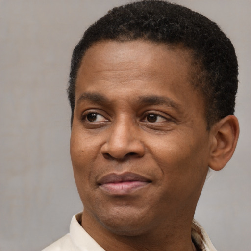 Joyful latino adult male with short  brown hair and brown eyes