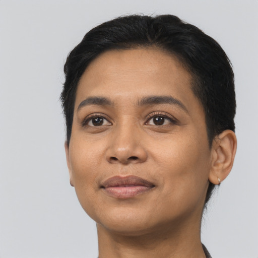 Joyful latino young-adult female with short  black hair and brown eyes