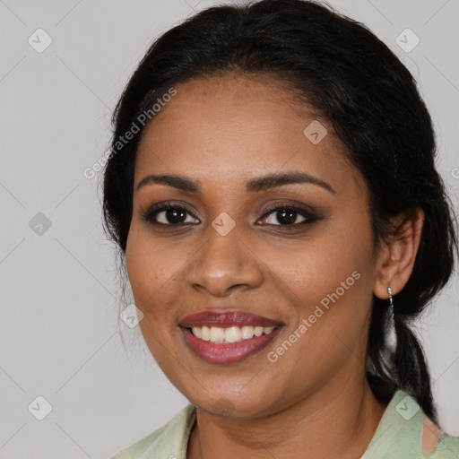 Joyful black young-adult female with medium  brown hair and brown eyes