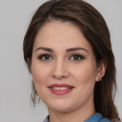 Joyful white young-adult female with medium  brown hair and brown eyes