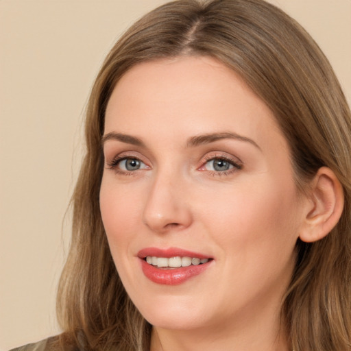 Joyful white adult female with long  brown hair and brown eyes