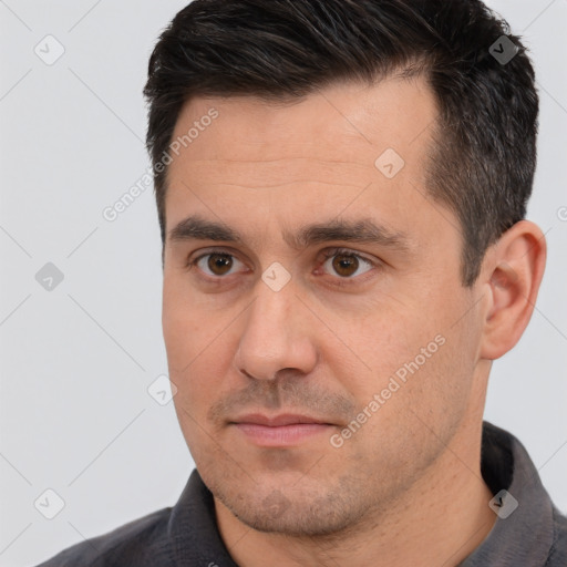 Joyful white young-adult male with short  black hair and brown eyes