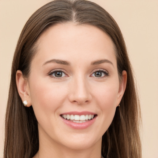 Joyful white young-adult female with long  brown hair and grey eyes