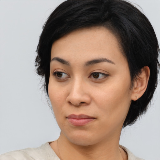 Joyful asian young-adult female with medium  black hair and brown eyes