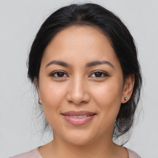 Joyful latino young-adult female with medium  brown hair and brown eyes