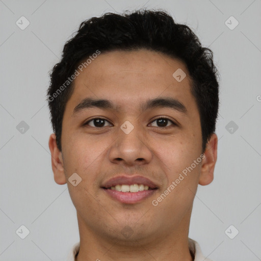 Joyful latino young-adult male with short  brown hair and brown eyes