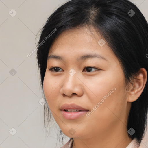 Joyful asian young-adult female with medium  black hair and brown eyes