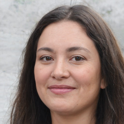 Joyful white adult female with long  brown hair and brown eyes