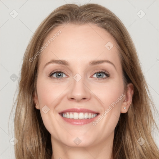 Joyful white young-adult female with long  brown hair and blue eyes